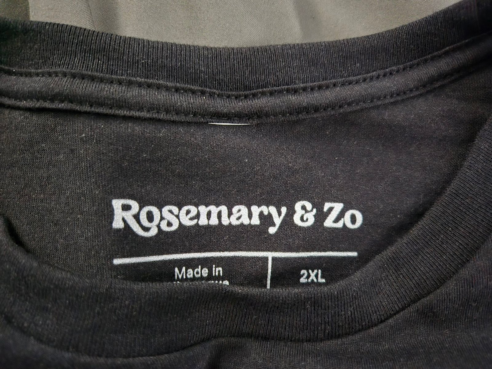 Close-up of the t-shirt tag with the Rosemary & Zo logo printed at the top